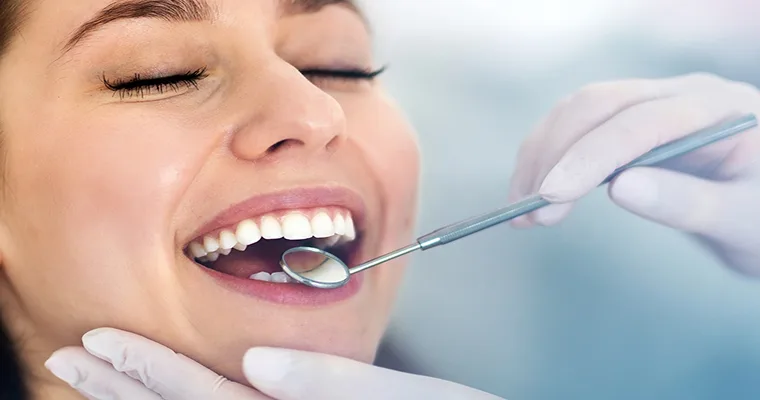 Porcelain Veneers with Prizm Dental & Veneers Female patient being examined for veneers.