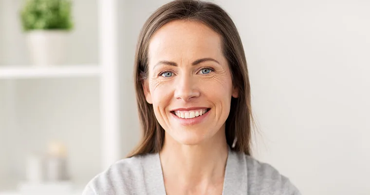A middle-aged woman smiling